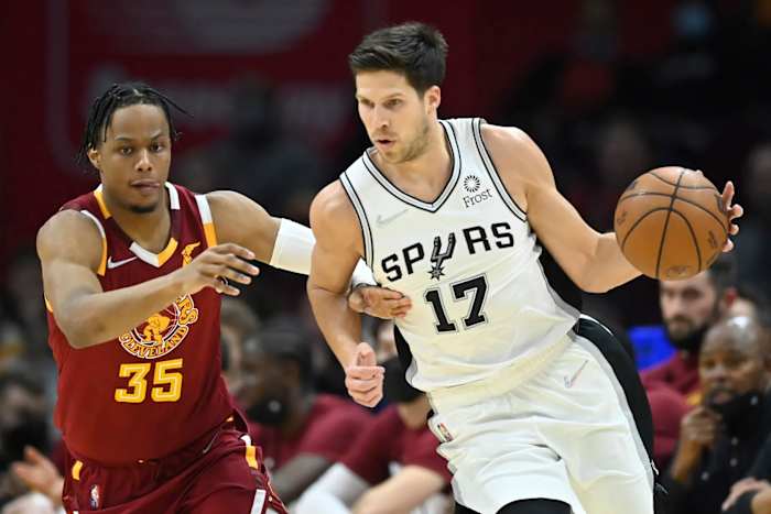 San Antonio Spurs guard Doug McDermott defended by Cleveland Cavaliers guard Isaac Okoro.